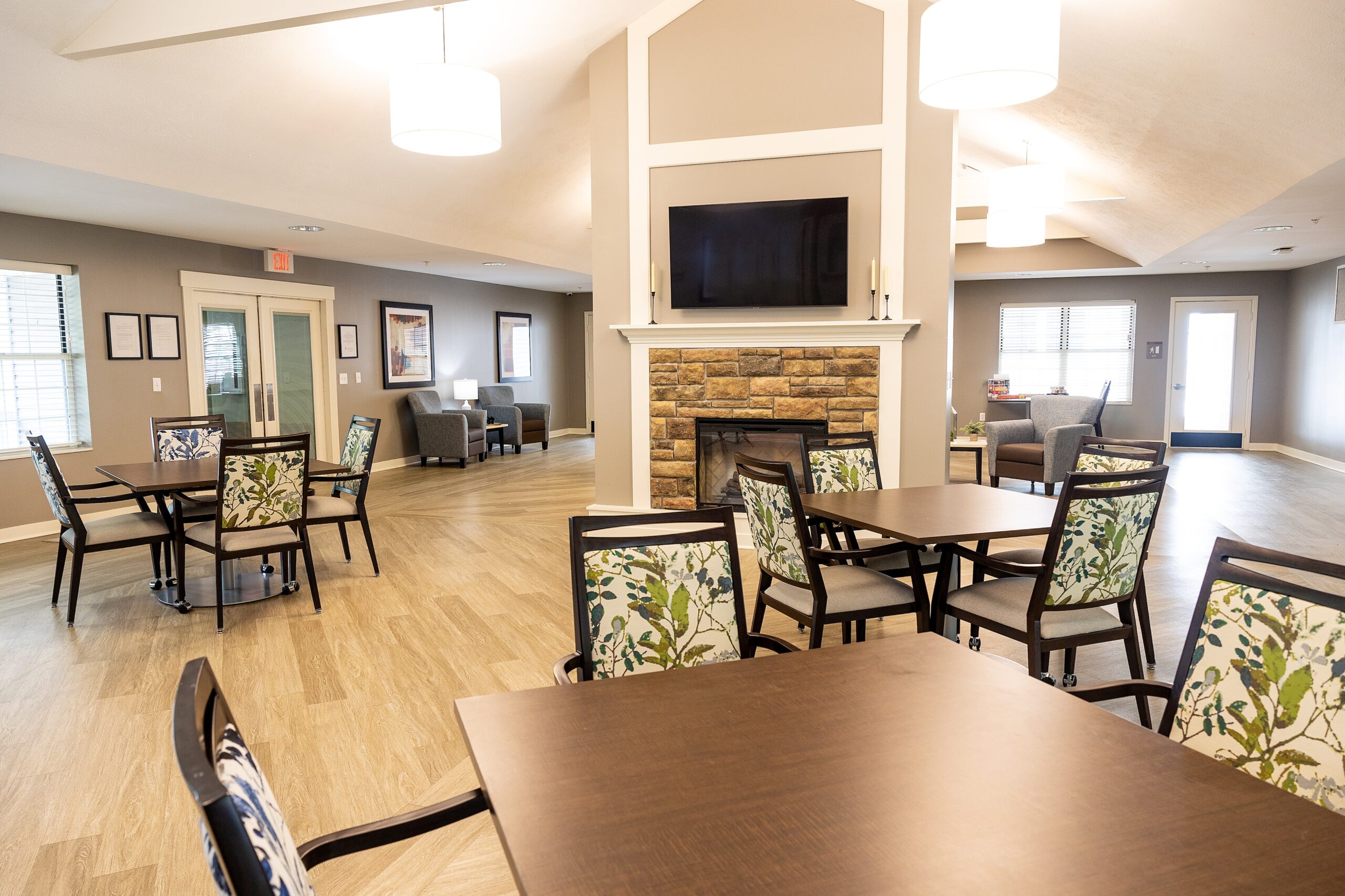 Bright common area with tables and chairs in the facility