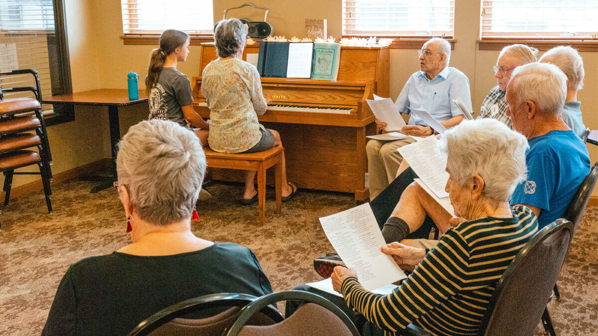Residents enjoying a music activity in an indoor setting