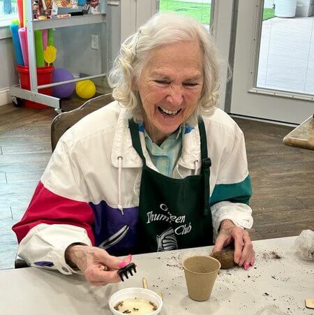 Resident enjoying an activity in a vibrant common area