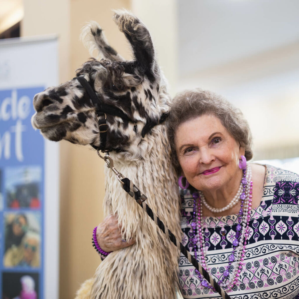 A resident with a llama in a common area