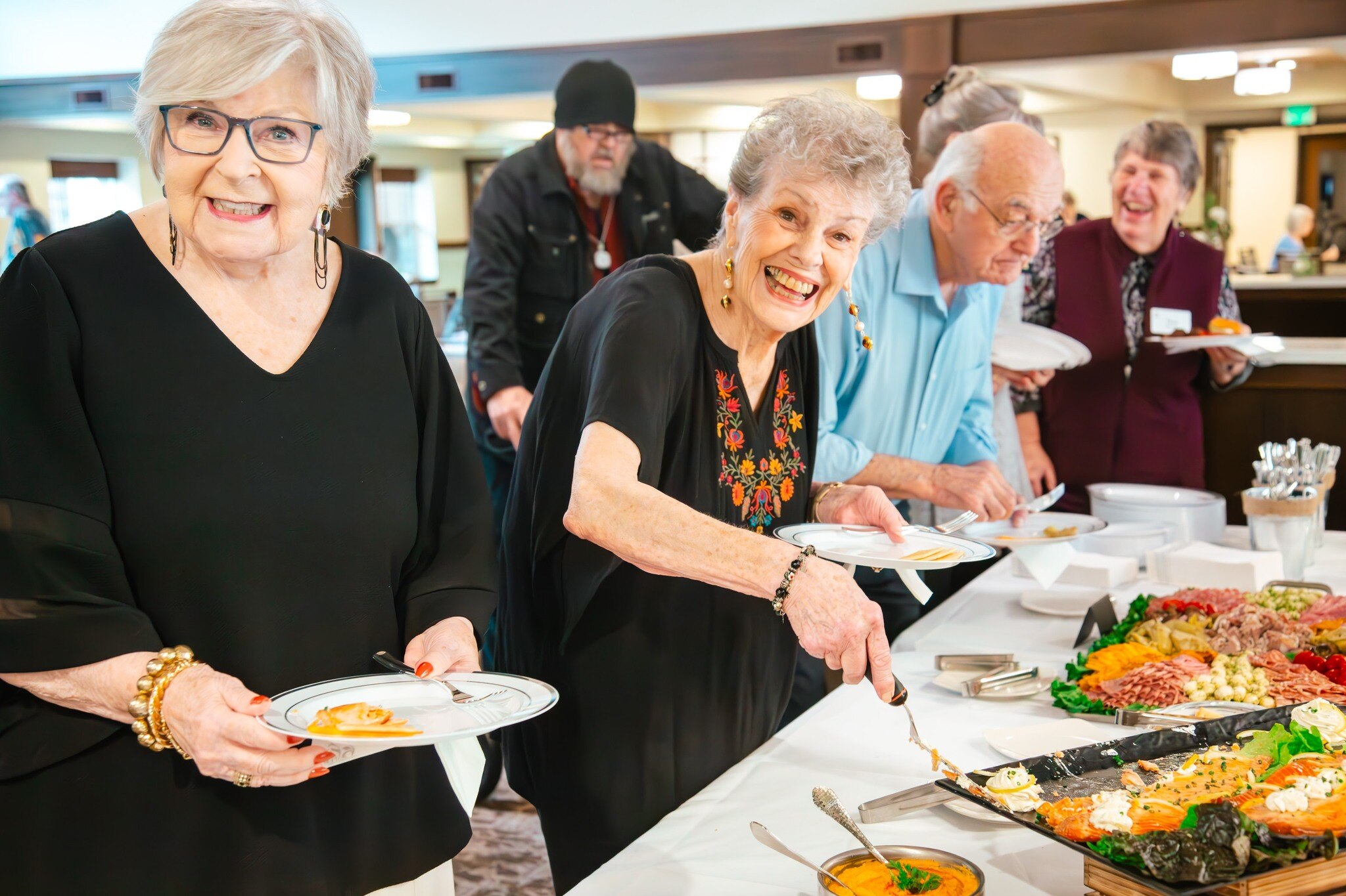 Residents serving themselves from a buffet during an event