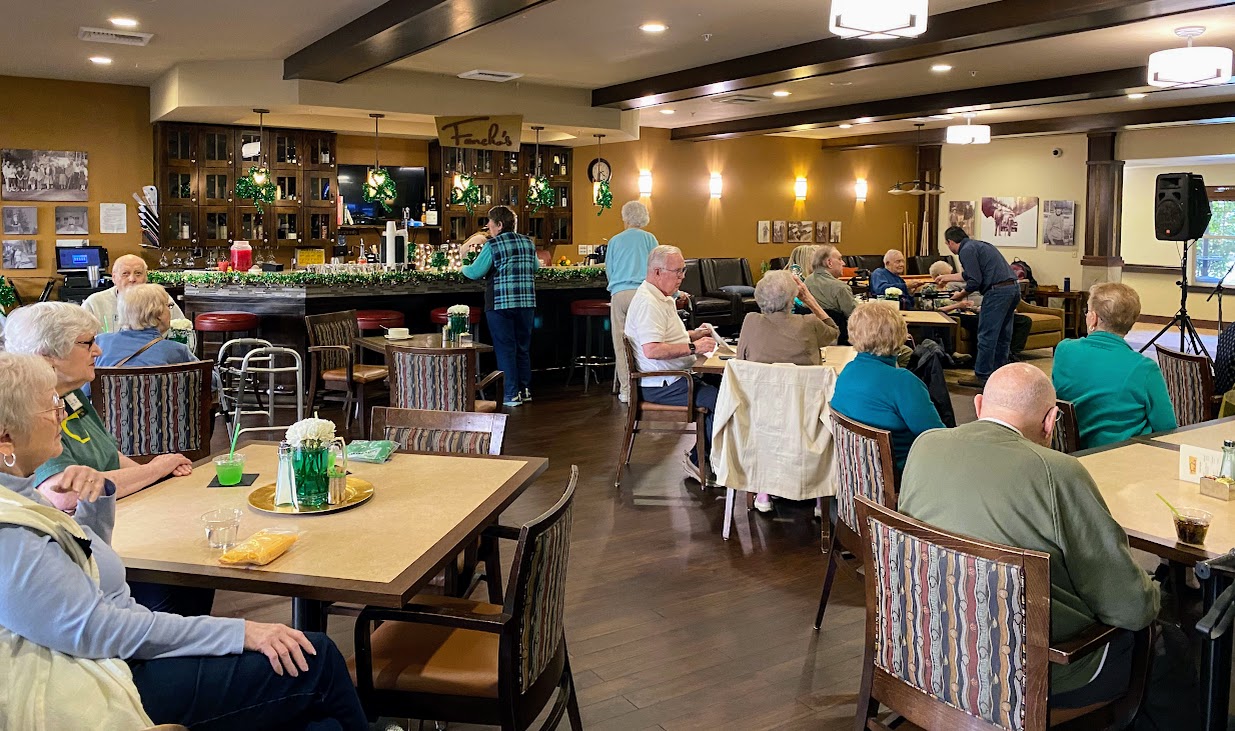 Residents enjoying activities in a lively common area