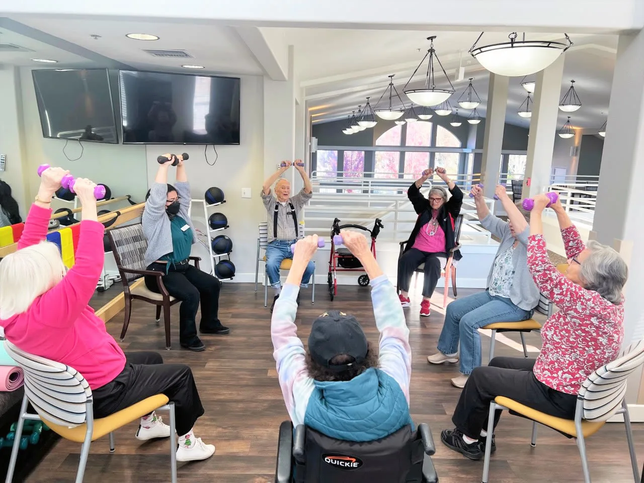 Residents participating in an exercise class in the activity room