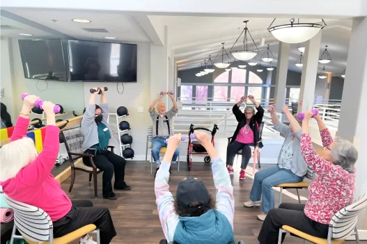 Residents participating in a physical activity class indoors