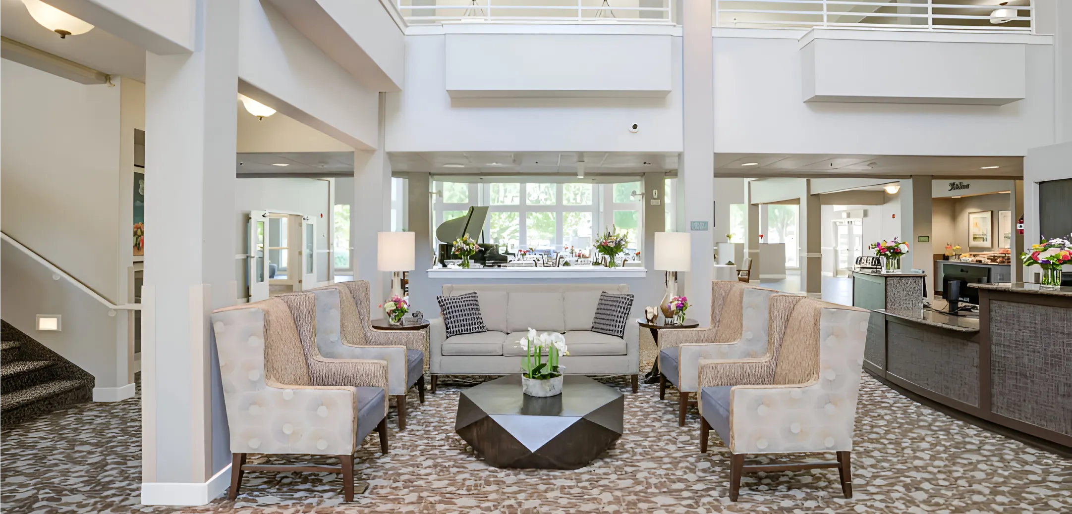 Bright lobby area with seating and floral arrangements