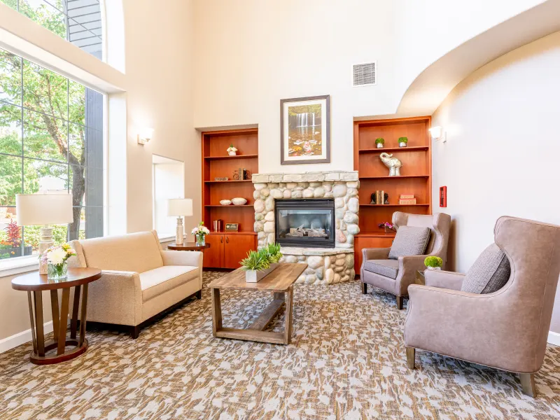 Bright common area with comfortable seating and a fireplace