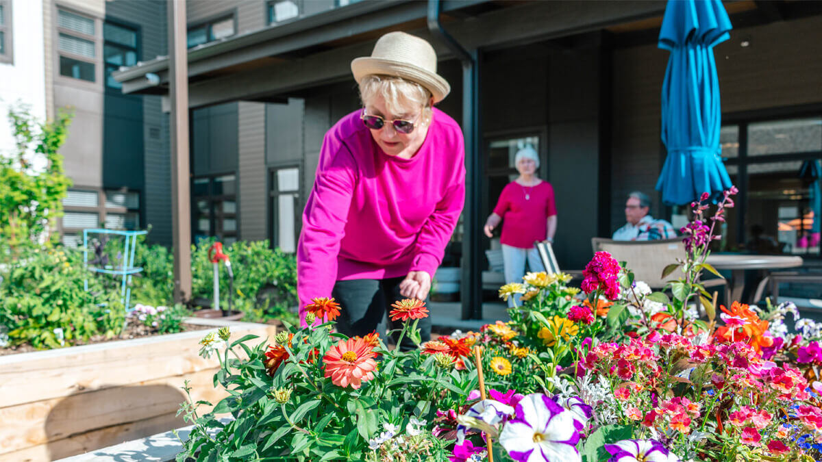 Resident gardening in a vibrant outdoor space
