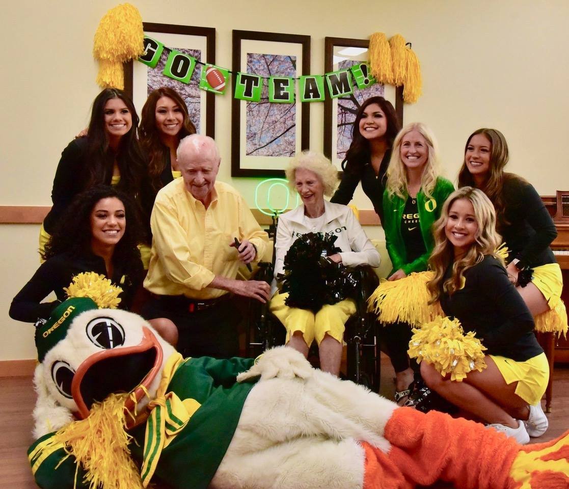 Residents and cheerleaders celebrating in a common area