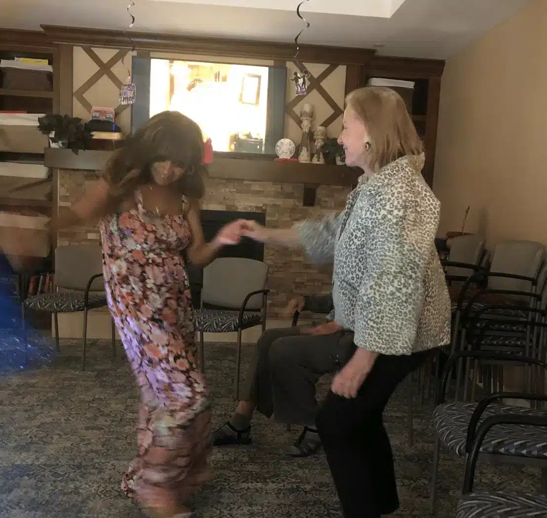 Residents dancing in a cozy activity room