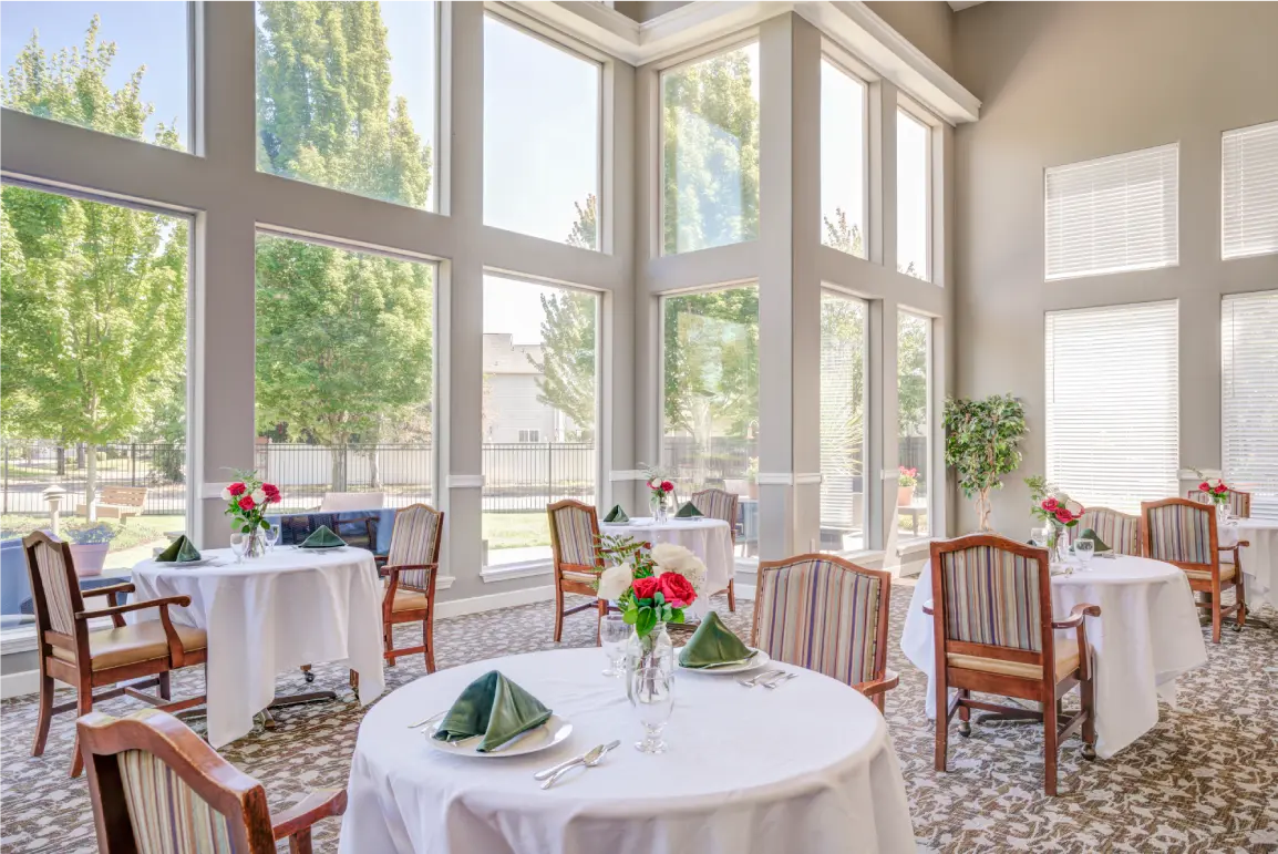 Bright dining room with tables set for a meal