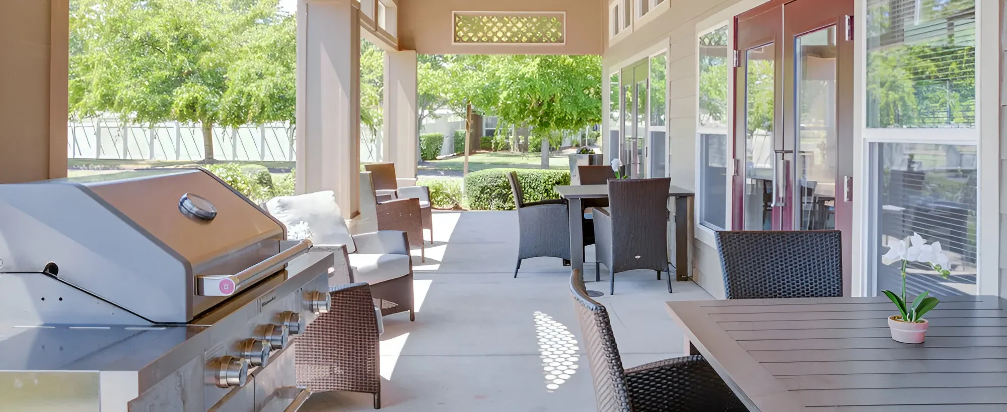 Outdoor patio with seating and a barbecue grill