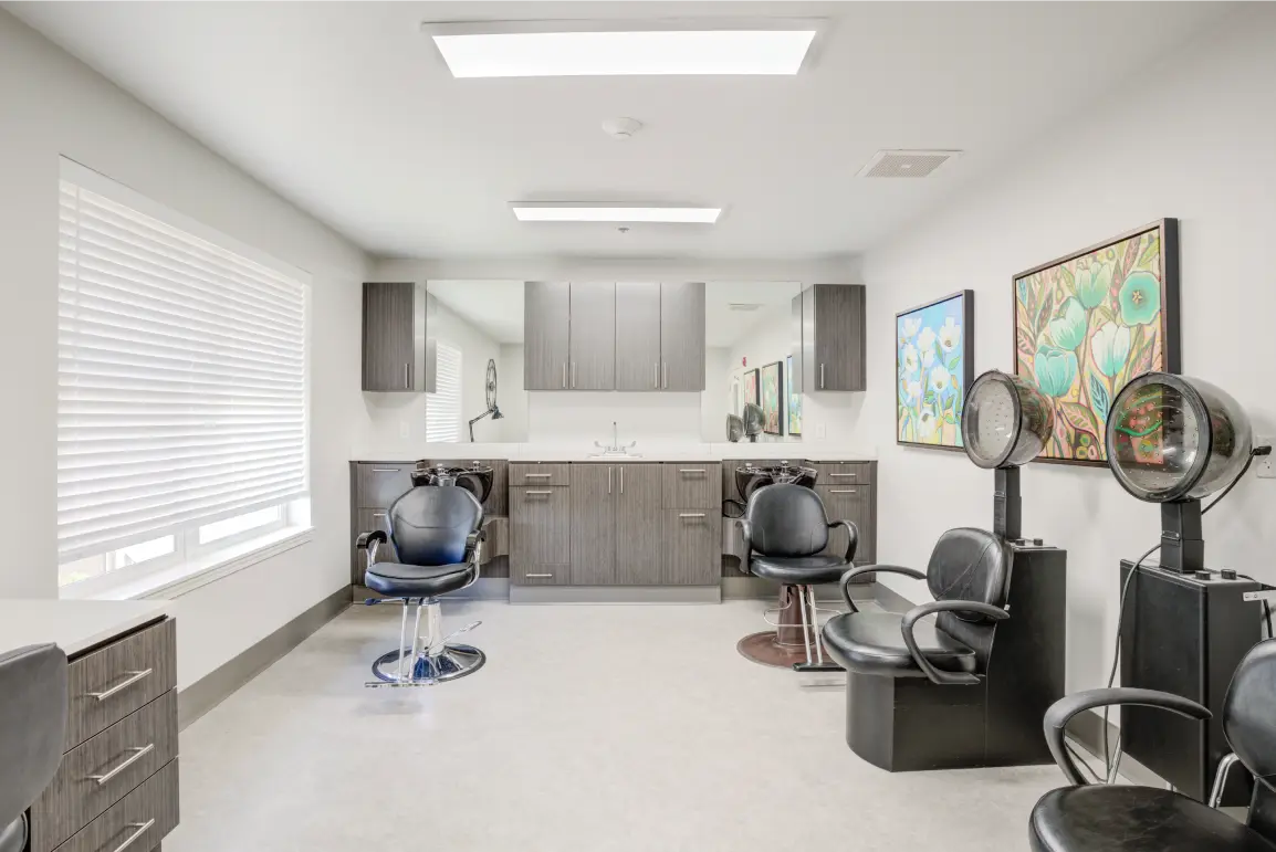 Brightly lit hair salon with styling chairs