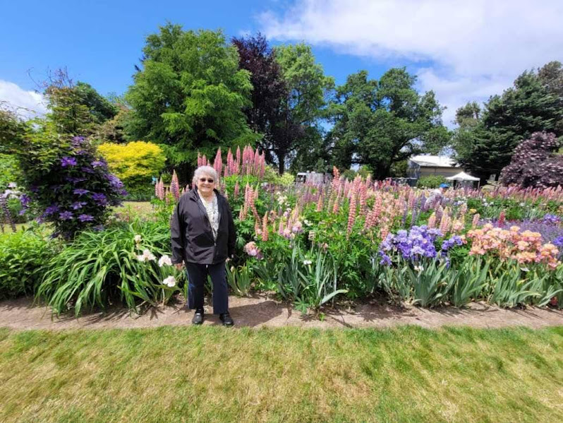 Resident enjoying a colorful flower garden