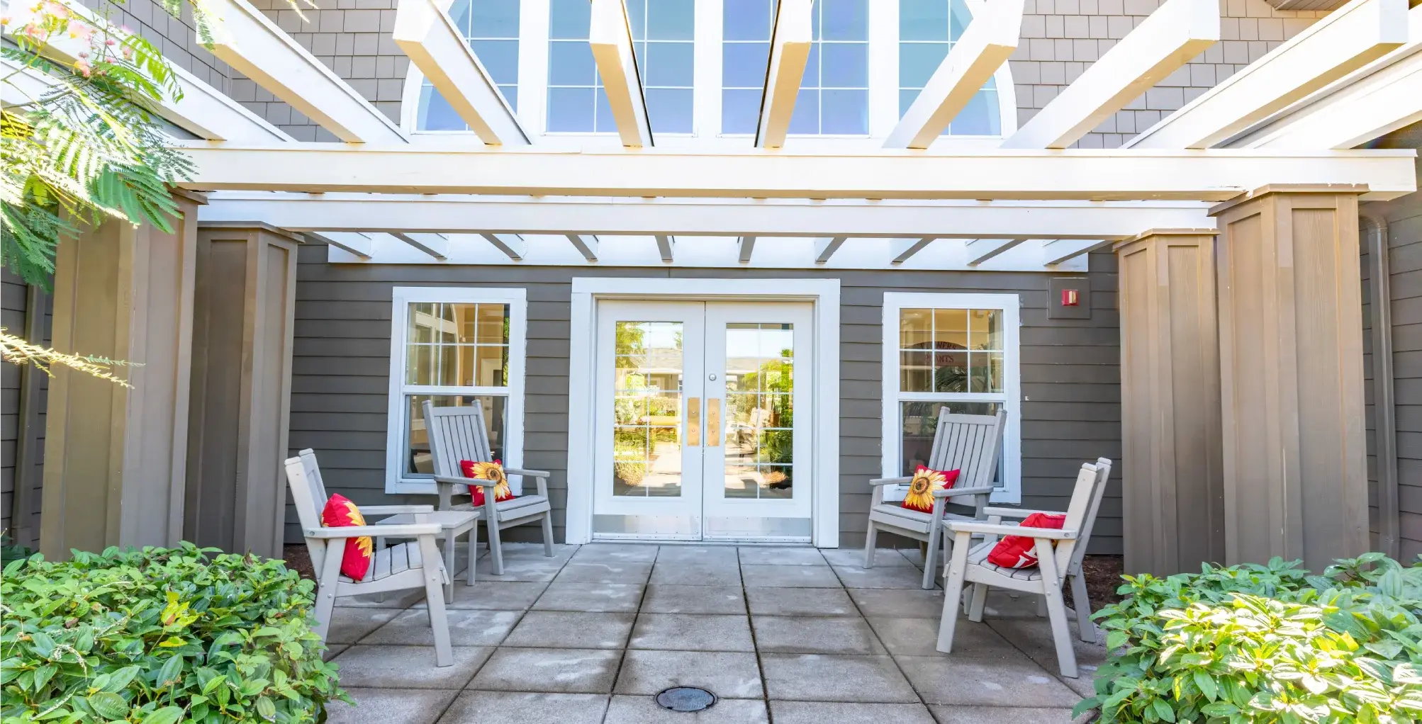 Outdoor seating area with chairs and plants