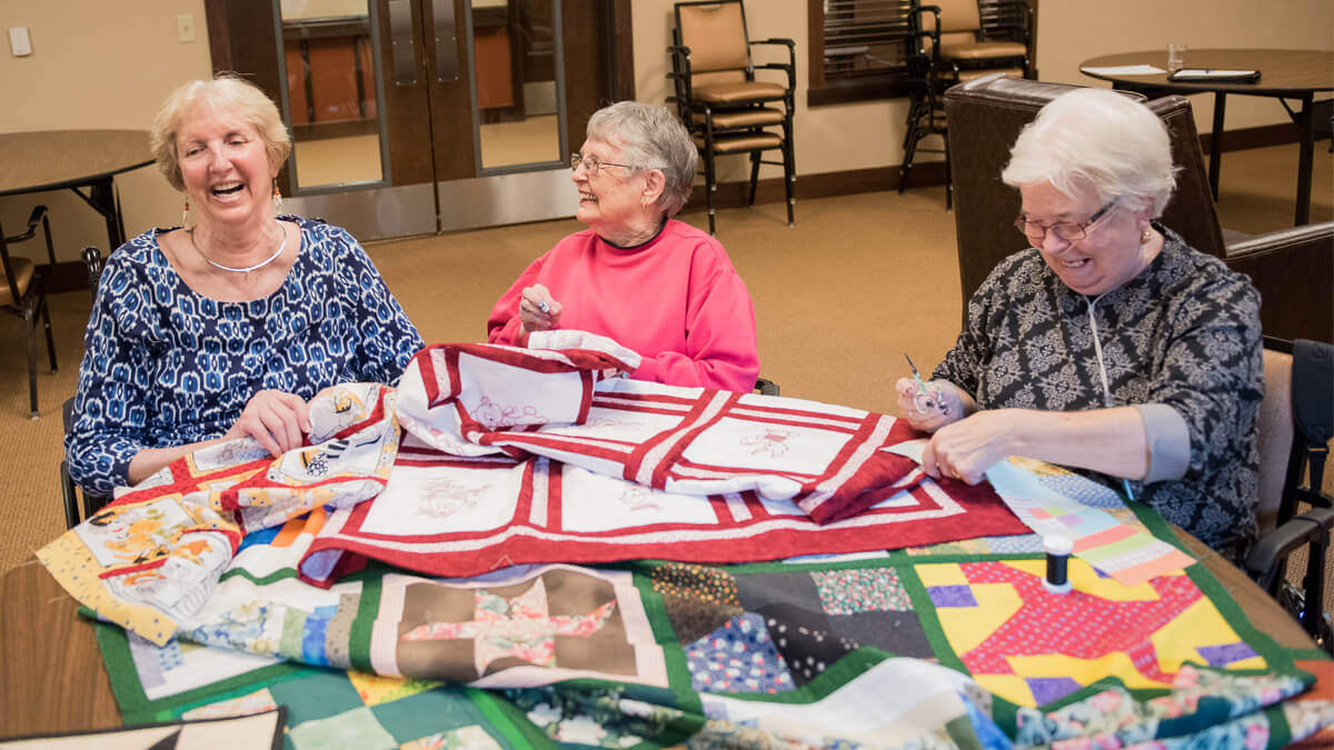 Residents engaged in a quilting activity