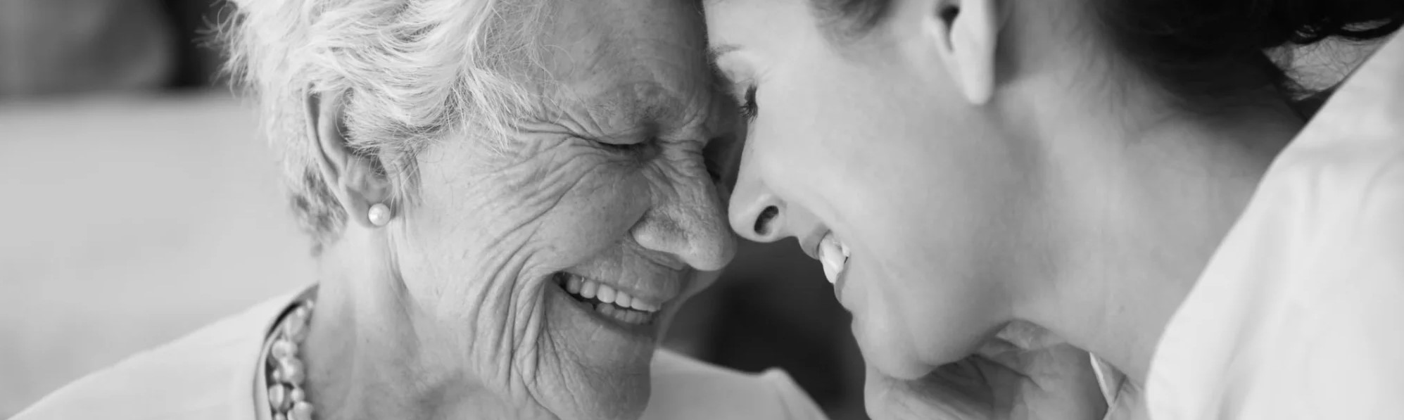 A joyful moment shared between a senior and young caregiver