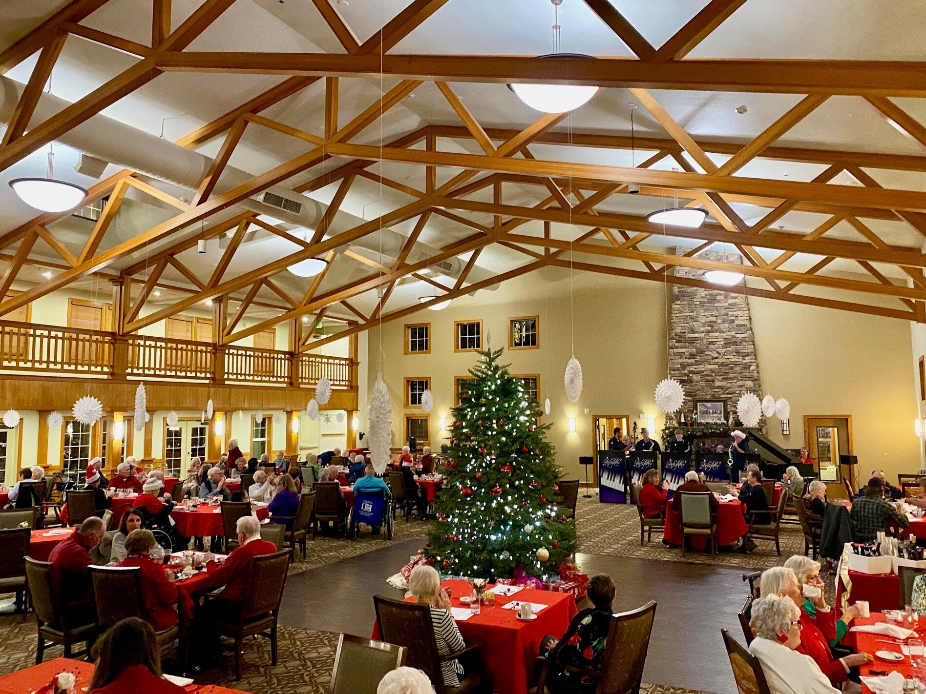 Residents enjoying a holiday gathering in a decorated common area