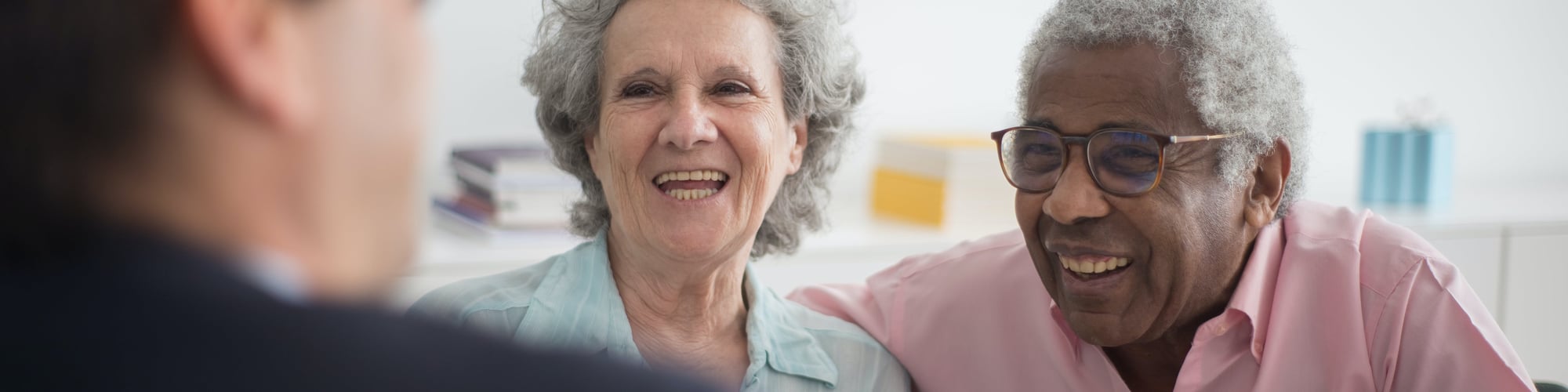 Two smiling seniors enjoying conversation