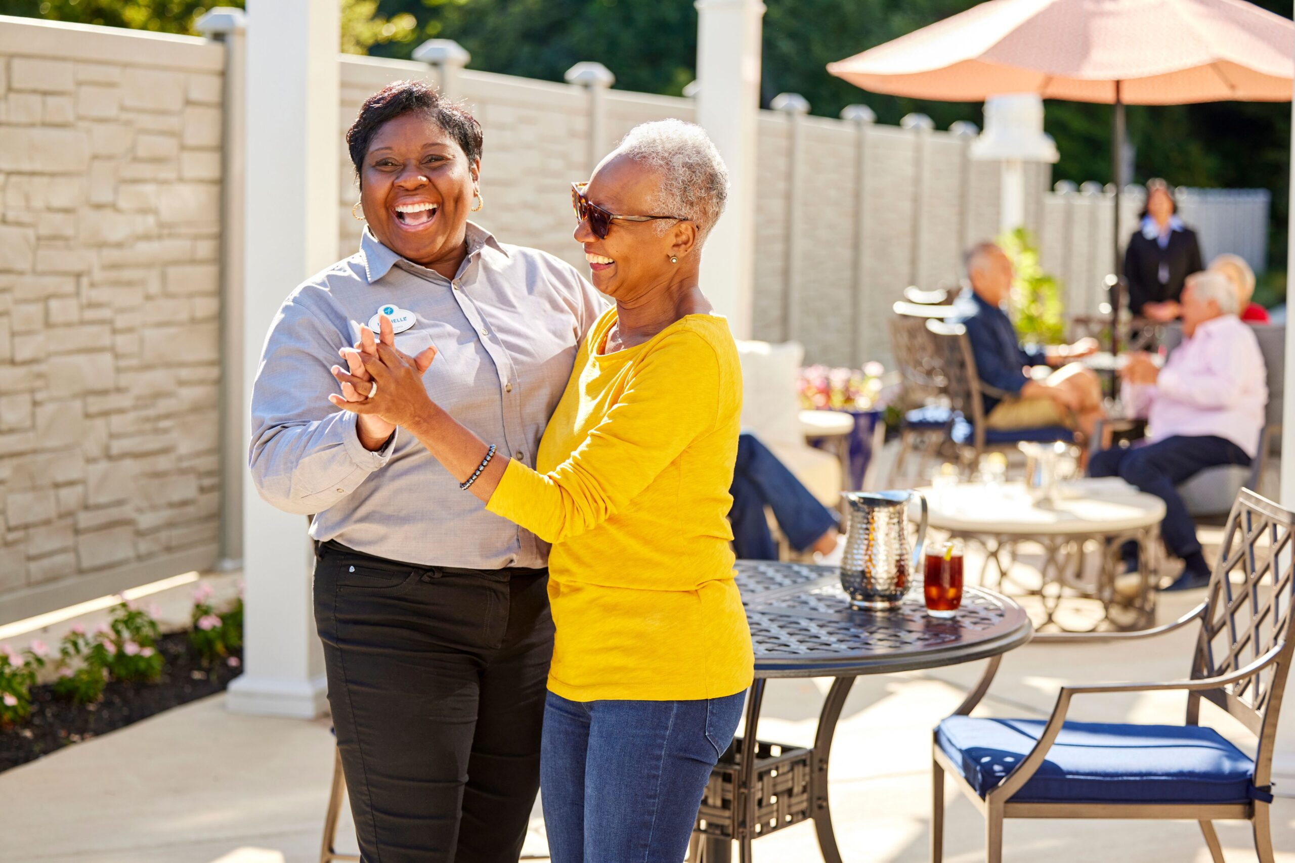 Residents dancing and enjoying a sunny outdoor space