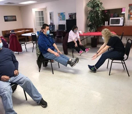 Residents engaging in seated exercise activities.