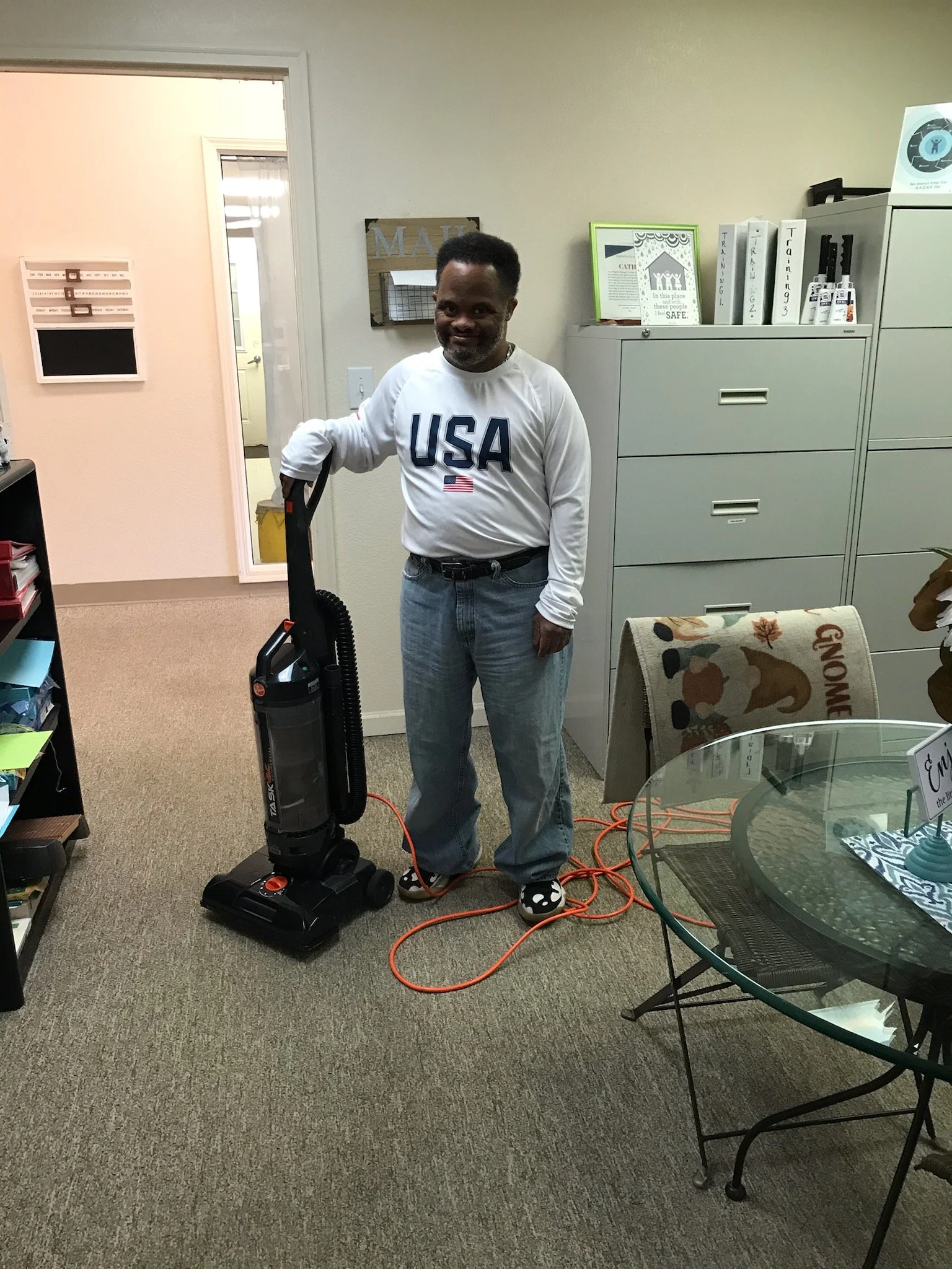Staff member using a vacuum in common area