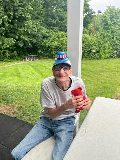 Resident enjoying outdoor activity with a toy.