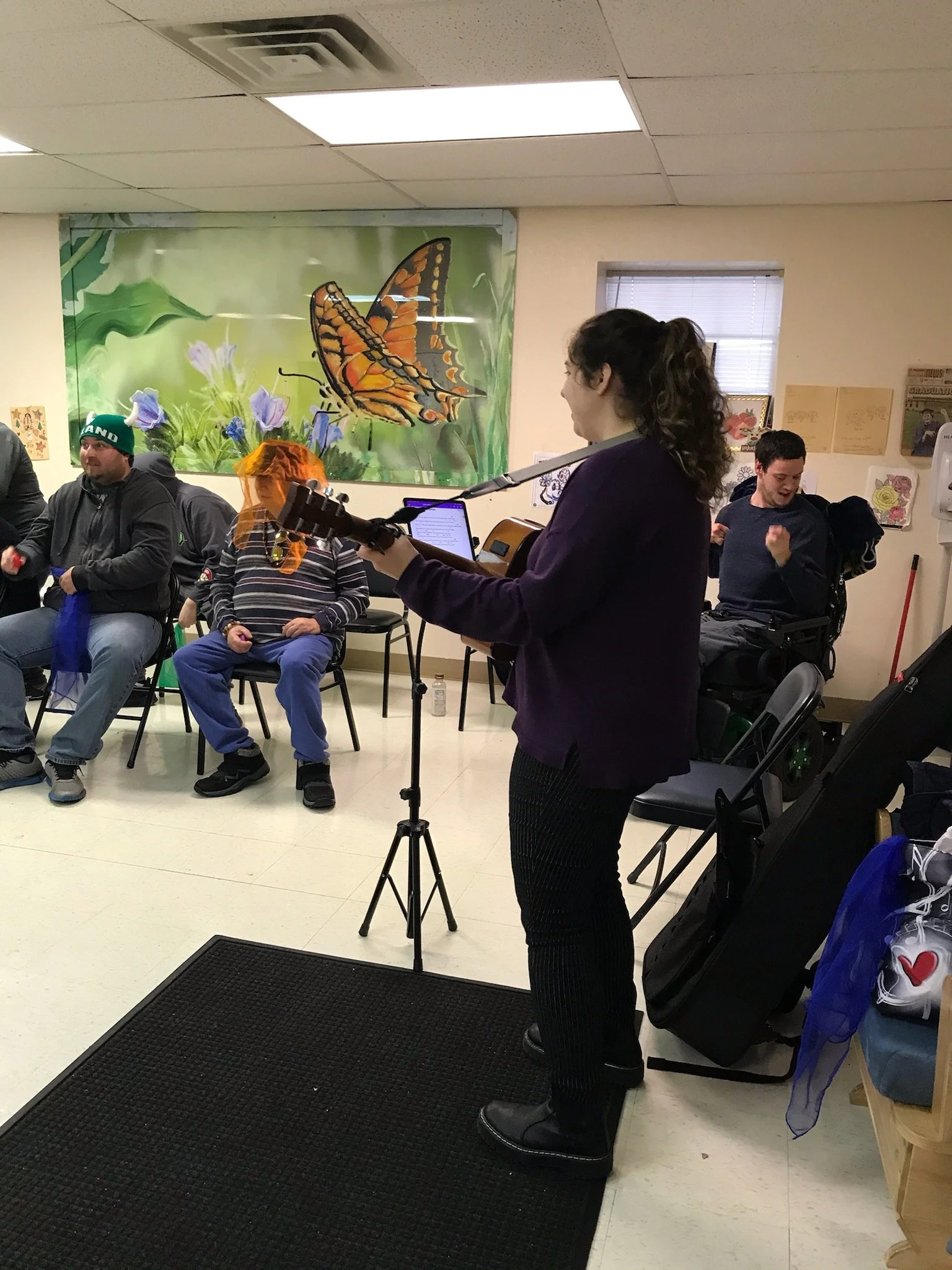 Musician performing for residents in common room