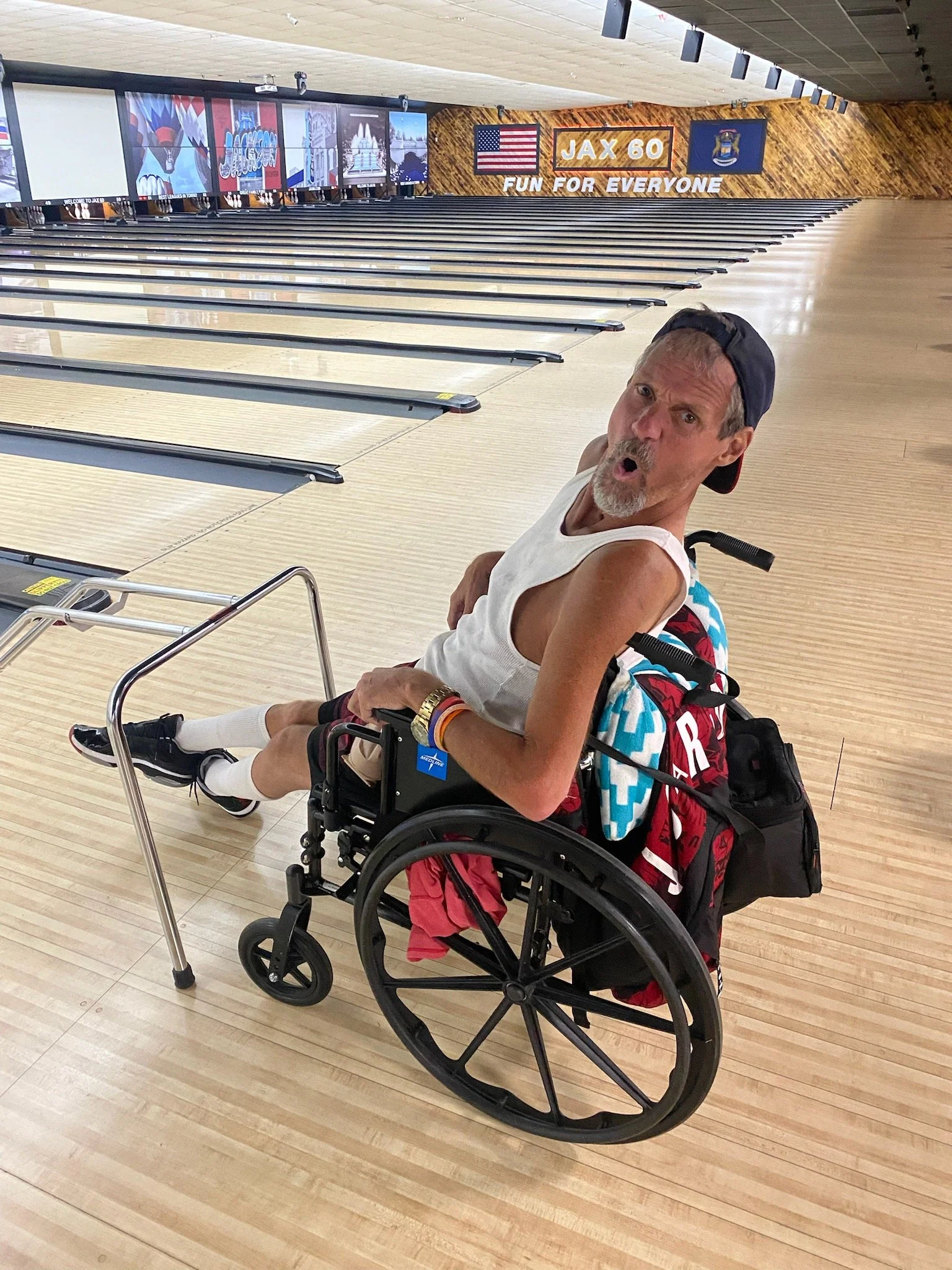 Resident enjoying bowling in a facility activity.