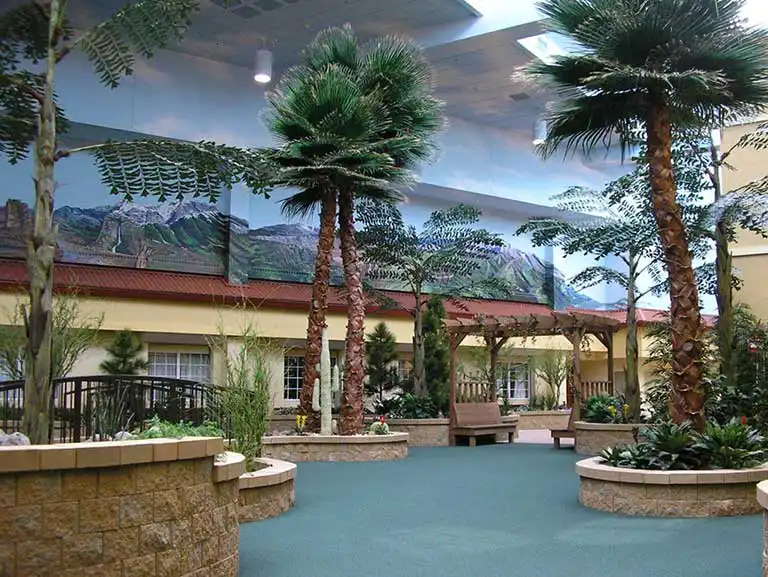 Interior view featuring tropical plants and seating