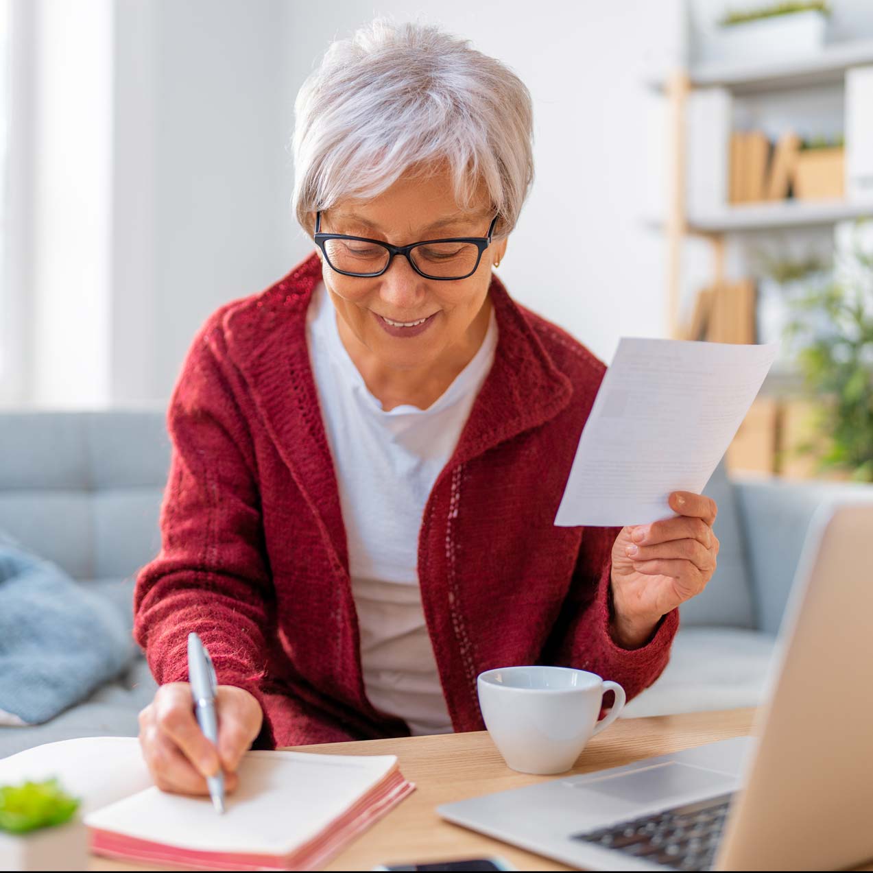 Senior woman engaging in a writing activity.