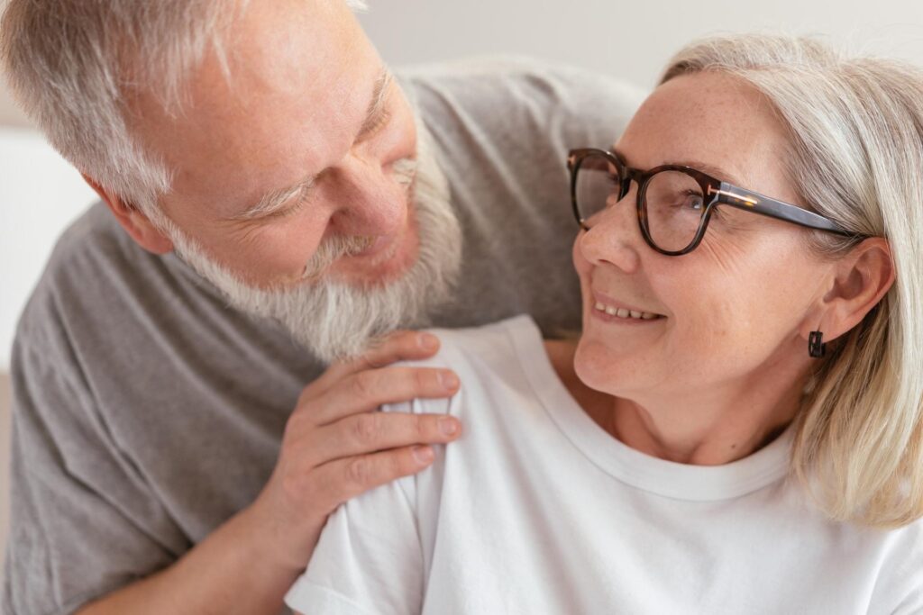 Elderly couple smiling at each other