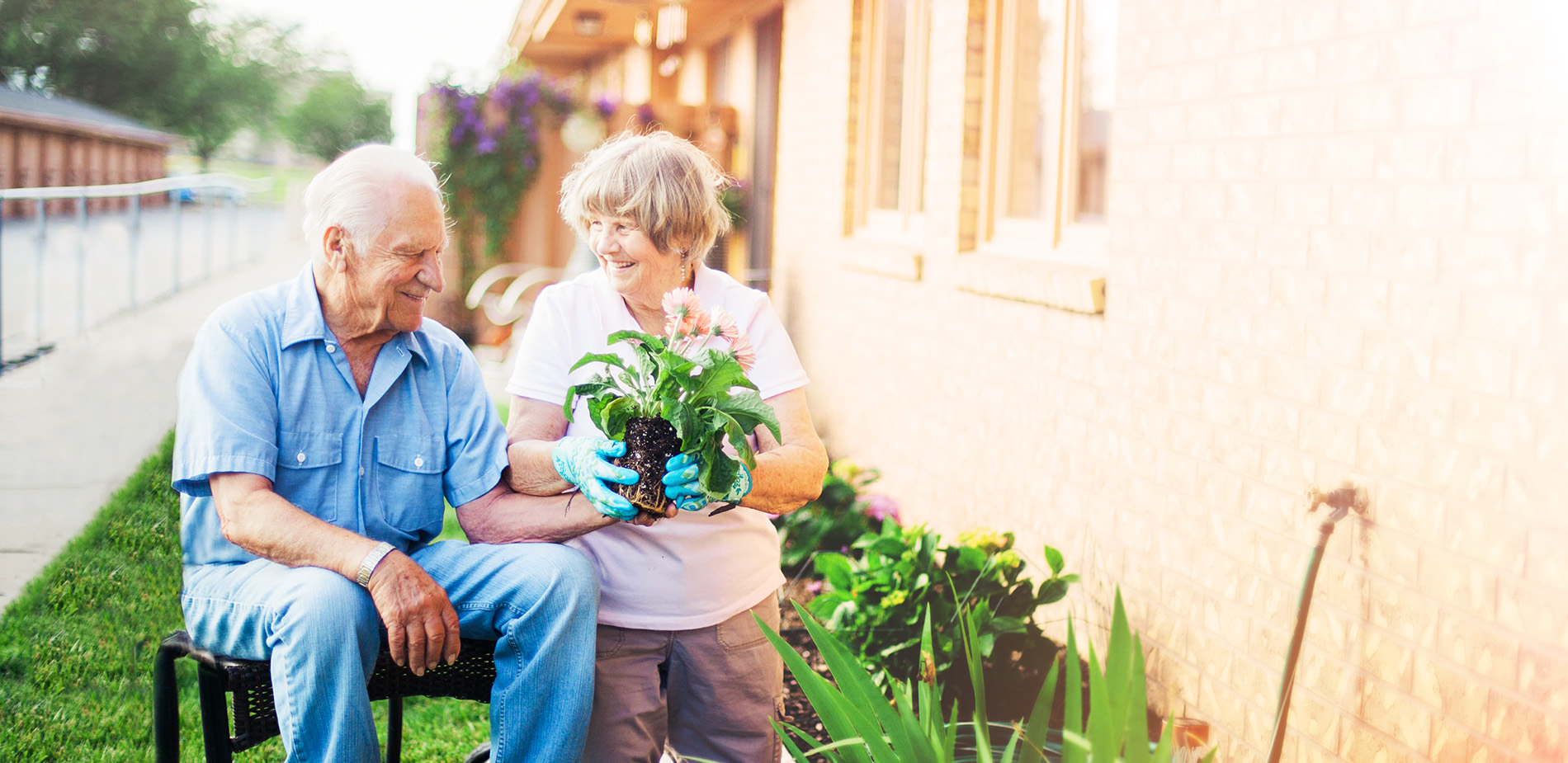 Two seniors gardening outside together.