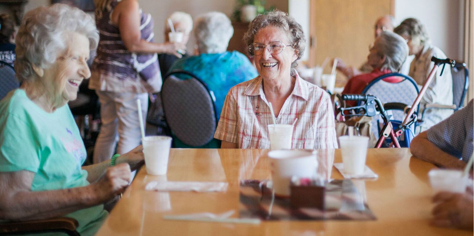 Residents enjoying a meal together in a common area.