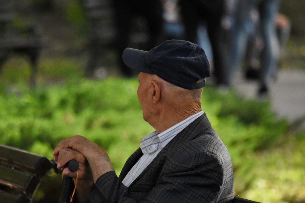Elderly man sitting outdoors in a park