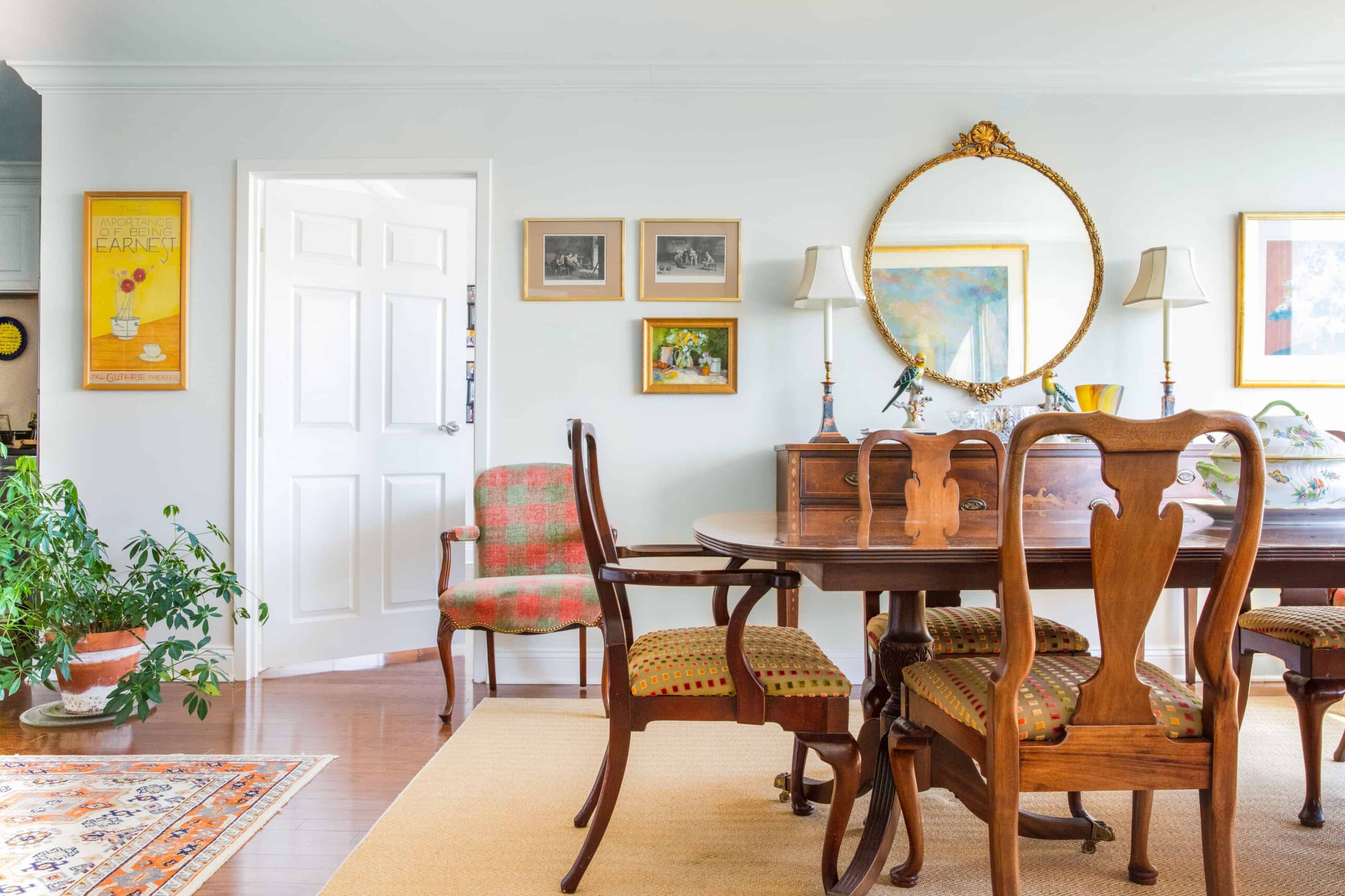 Bright dining area with wooden furniture and artwork.