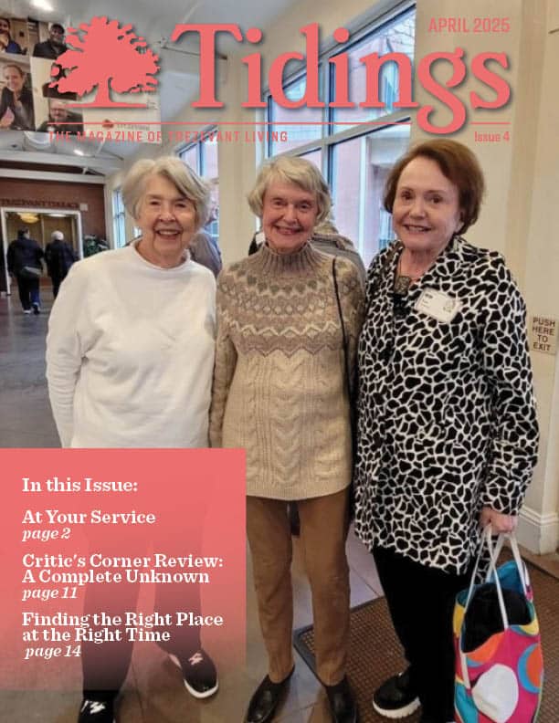 Three smiling residents in a common area.
