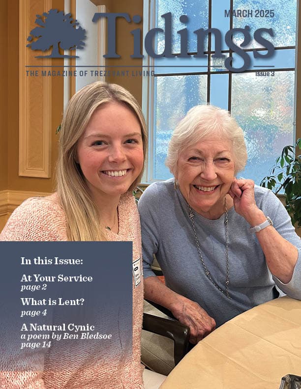 Resident and staff member smiling in a common area