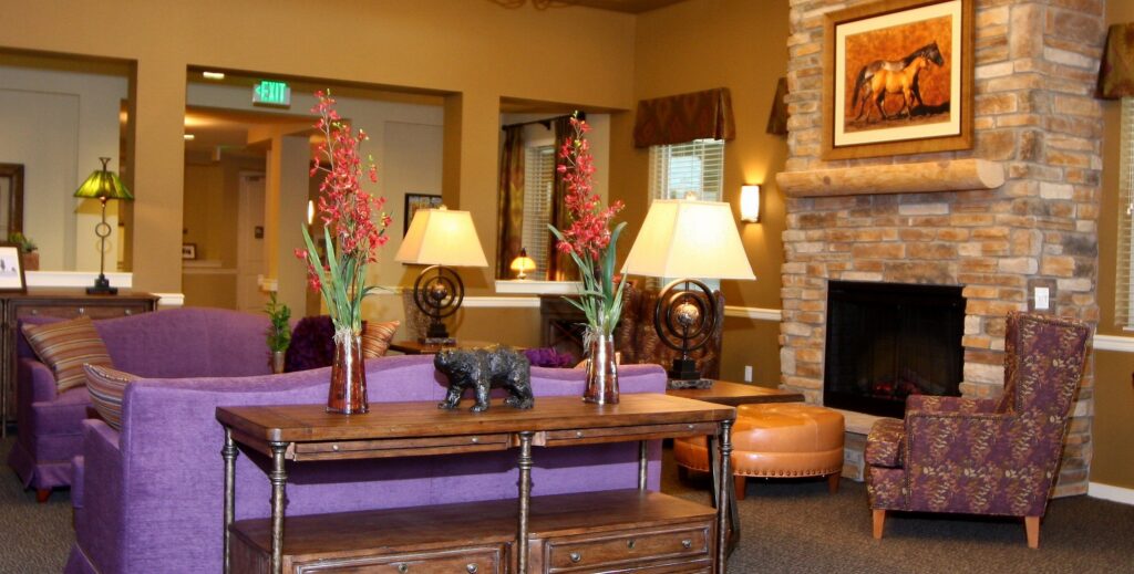 Cozy common area with purple sofas and decorative elements.