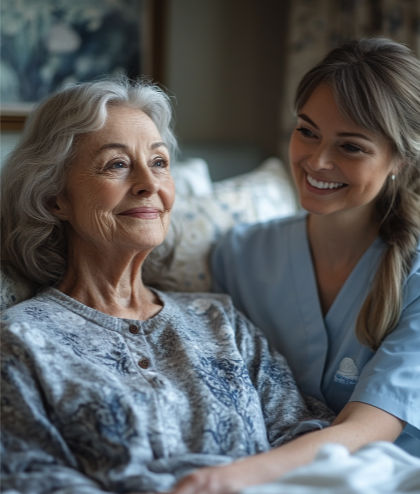 A caregiver smiling at an elderly resident.