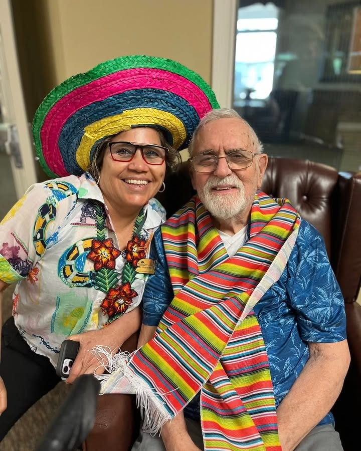 Staff member and resident enjoying a celebration.