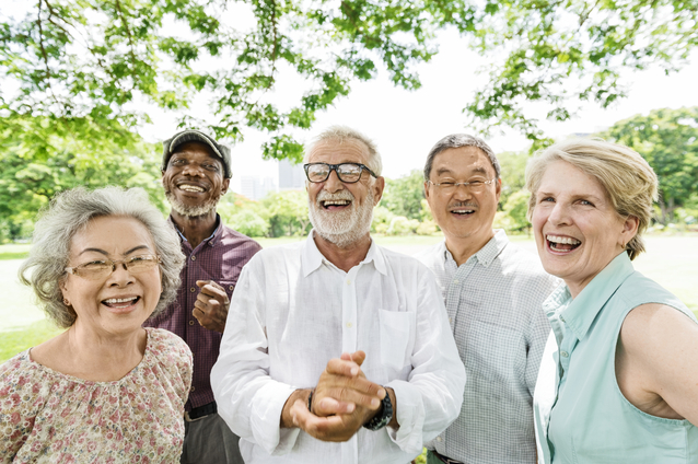 Group of smiling seniors enjoying time outdoors.
