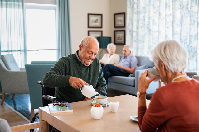 Residents enjoying tea in a common area.