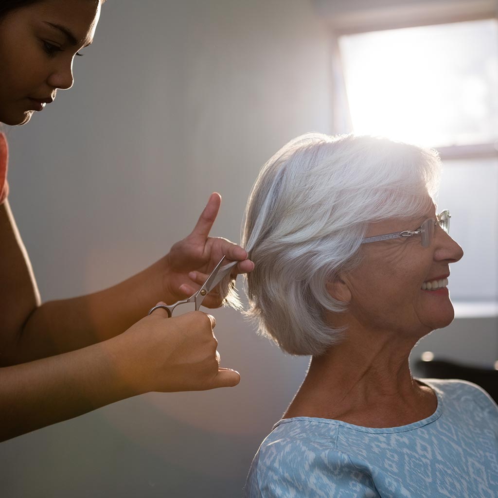 Senior woman getting her hair styled