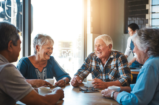 Seniors enjoying coffee at a table together