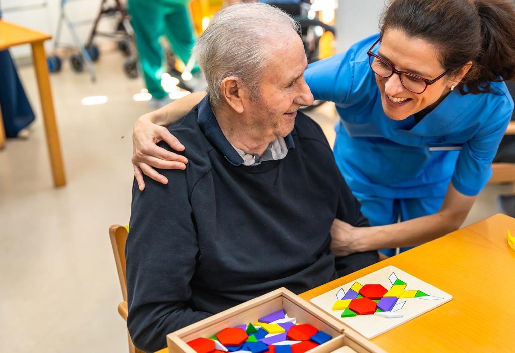 Staff engaging with a resident in an activity