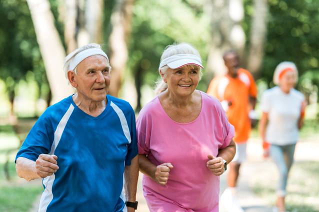 Seniors jogging together in a park