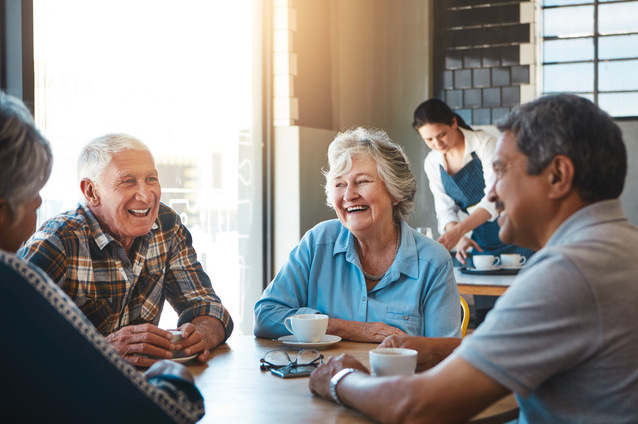 Seniors enjoying coffee and conversation in a common area