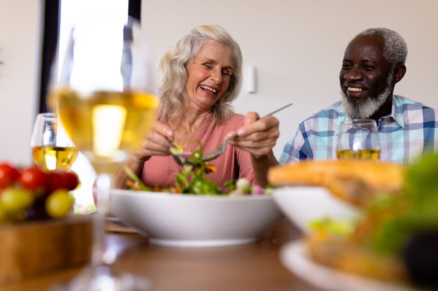 Two elderly individuals enjoying a meal together