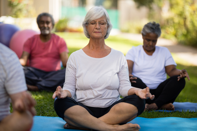 Group meditation session in a serene outdoor space.