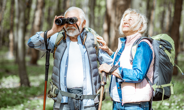 Elderly couple hiking in the woods